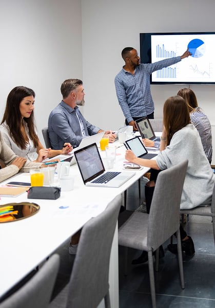 Young businessman giving presentation to his colleagues in modern office Young businessman giving presentation to his colleagues in modern office