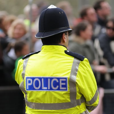 The back of a police officer in uniform The back of a police officer in uniform
