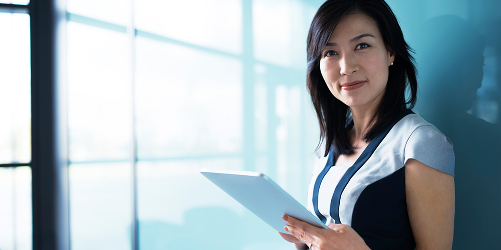Woman holding an iPad device Woman holding an iPad device